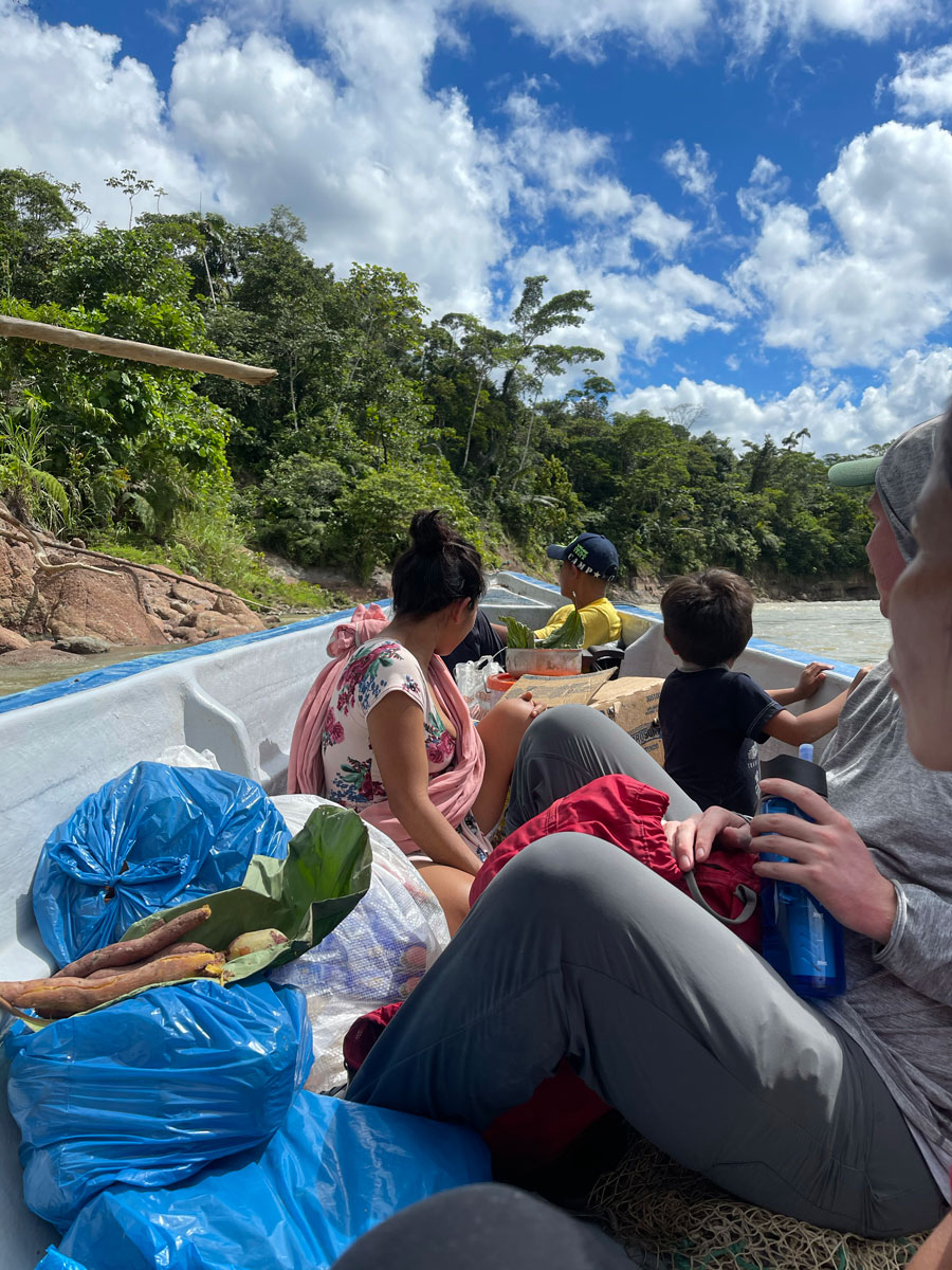 People Riding Down River on a Boat